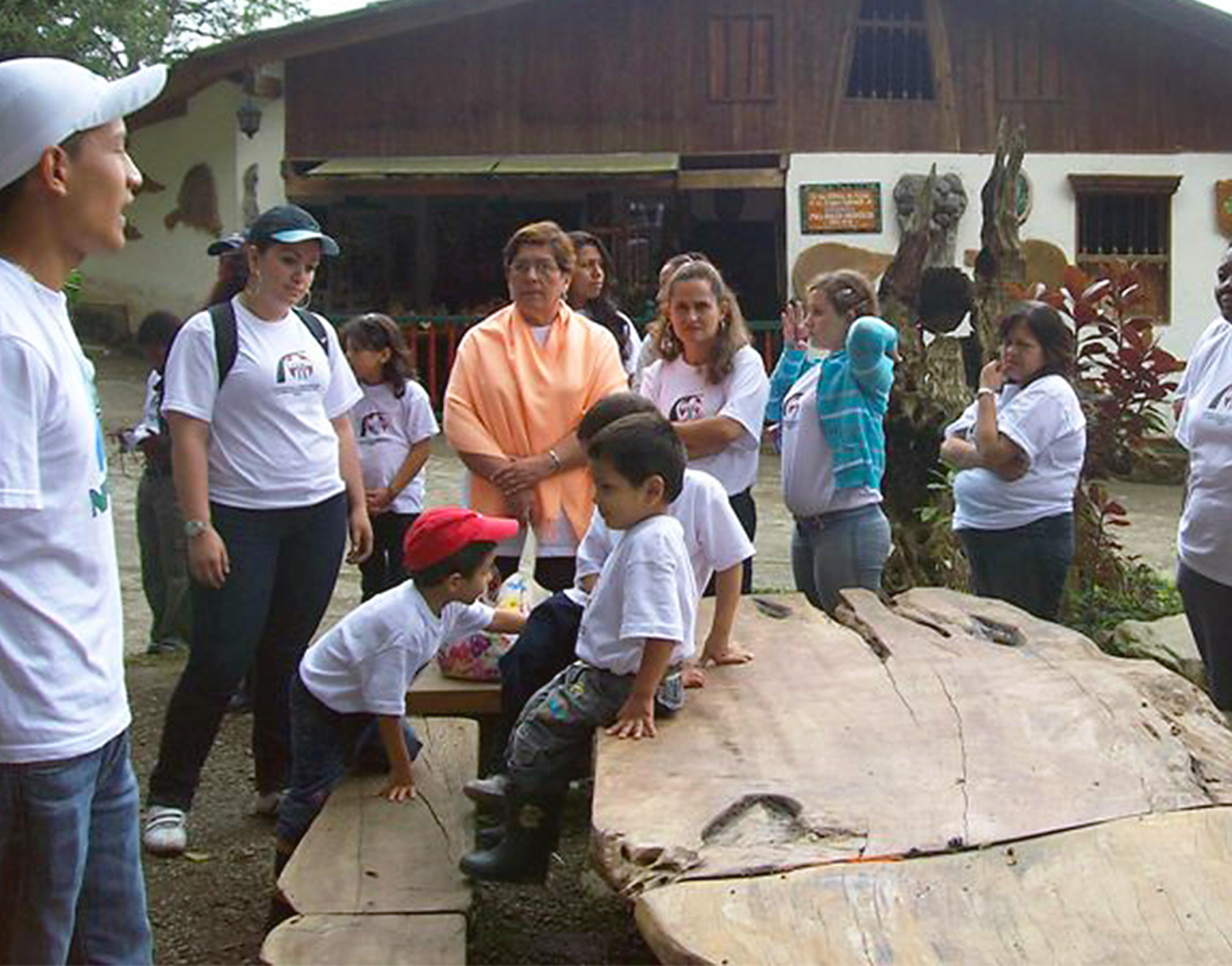 A man giving information to a group of adults and children