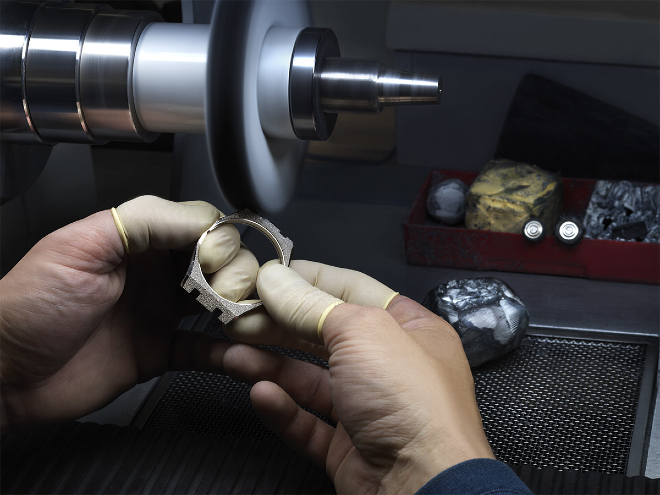 A watch case being polished by a watchmaker.