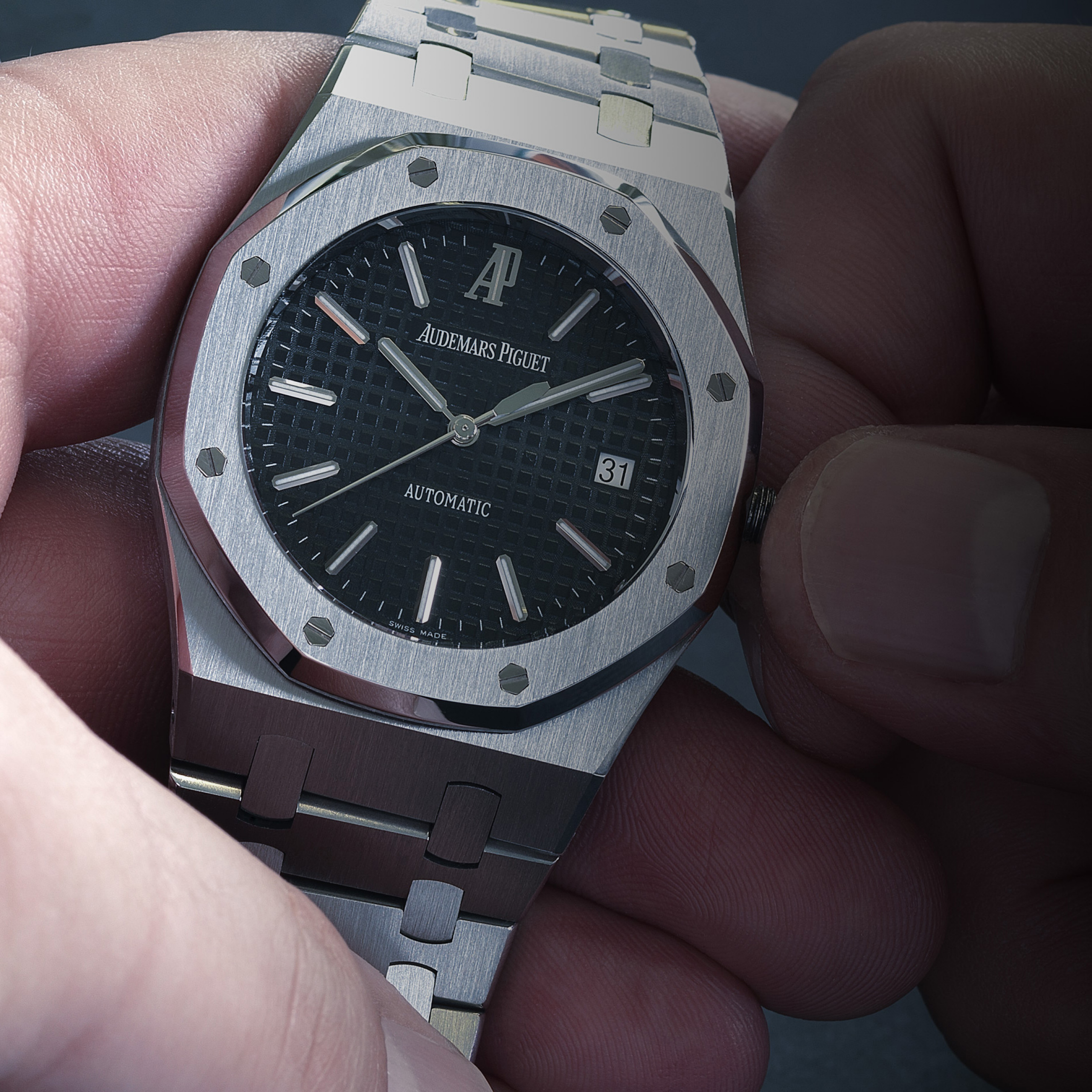 Someone winding a Royal Oak watch.