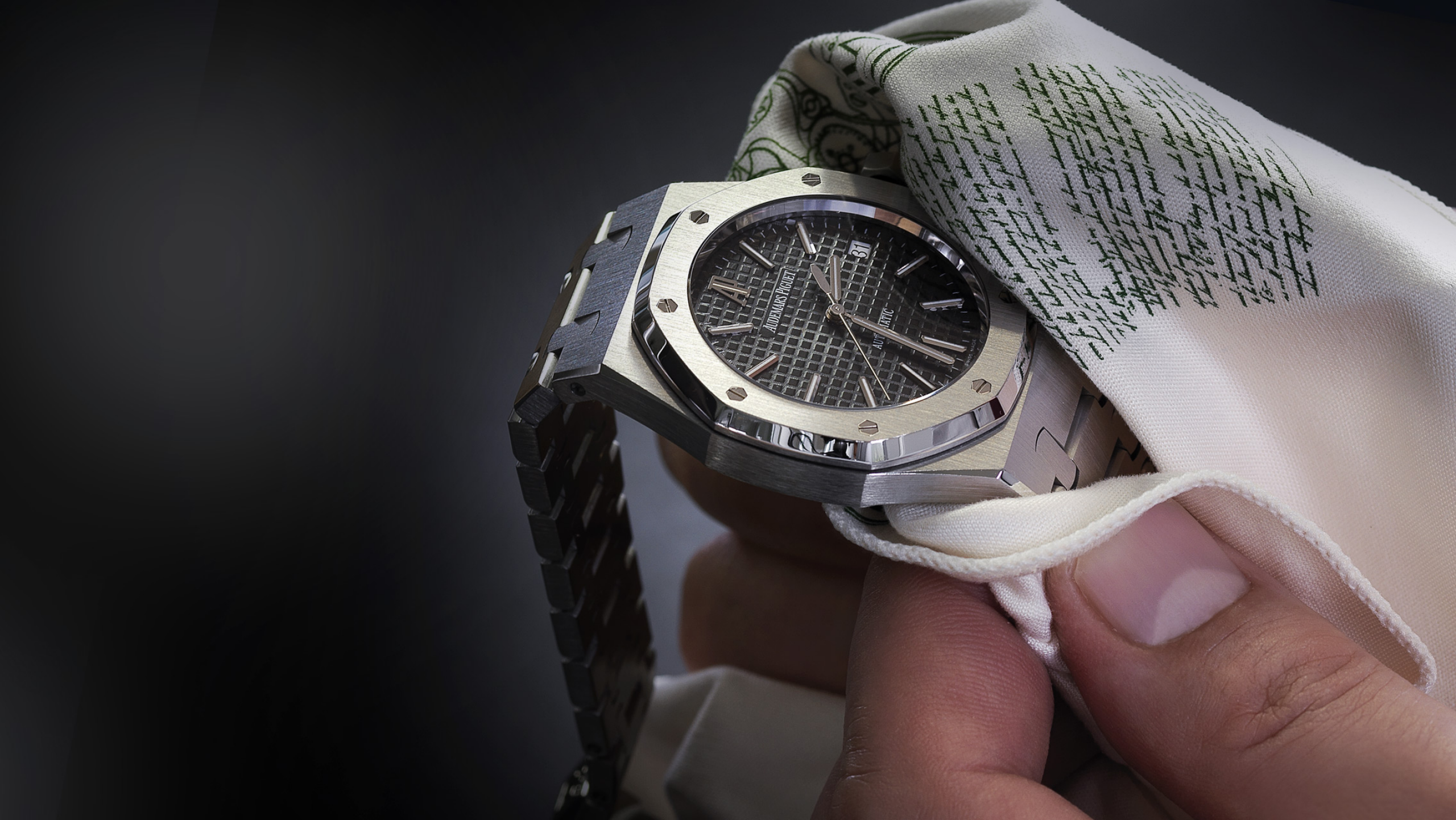 Someone cleaning a Royal Oak watch.