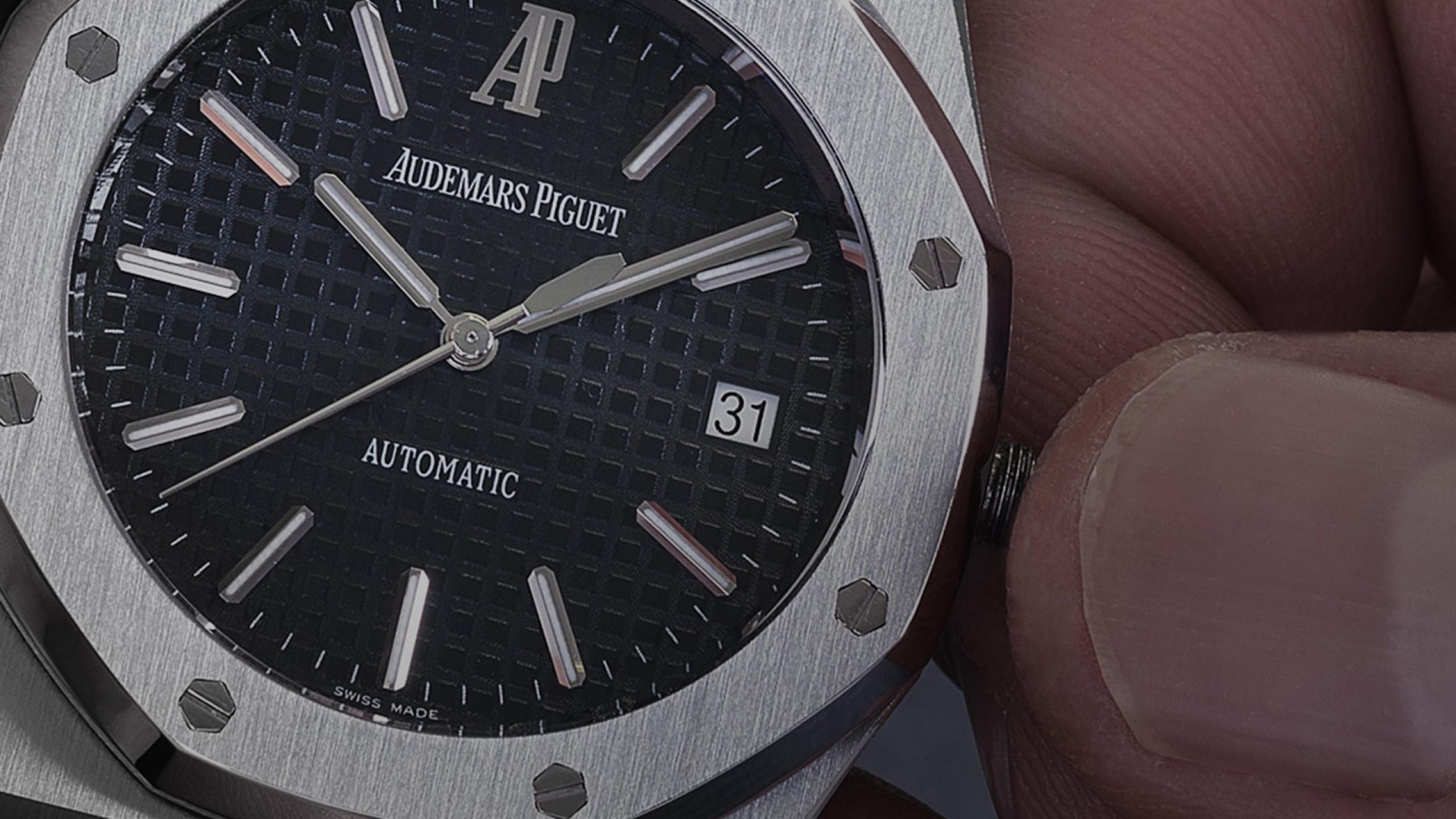 Someone winding a Royal Oak watch.