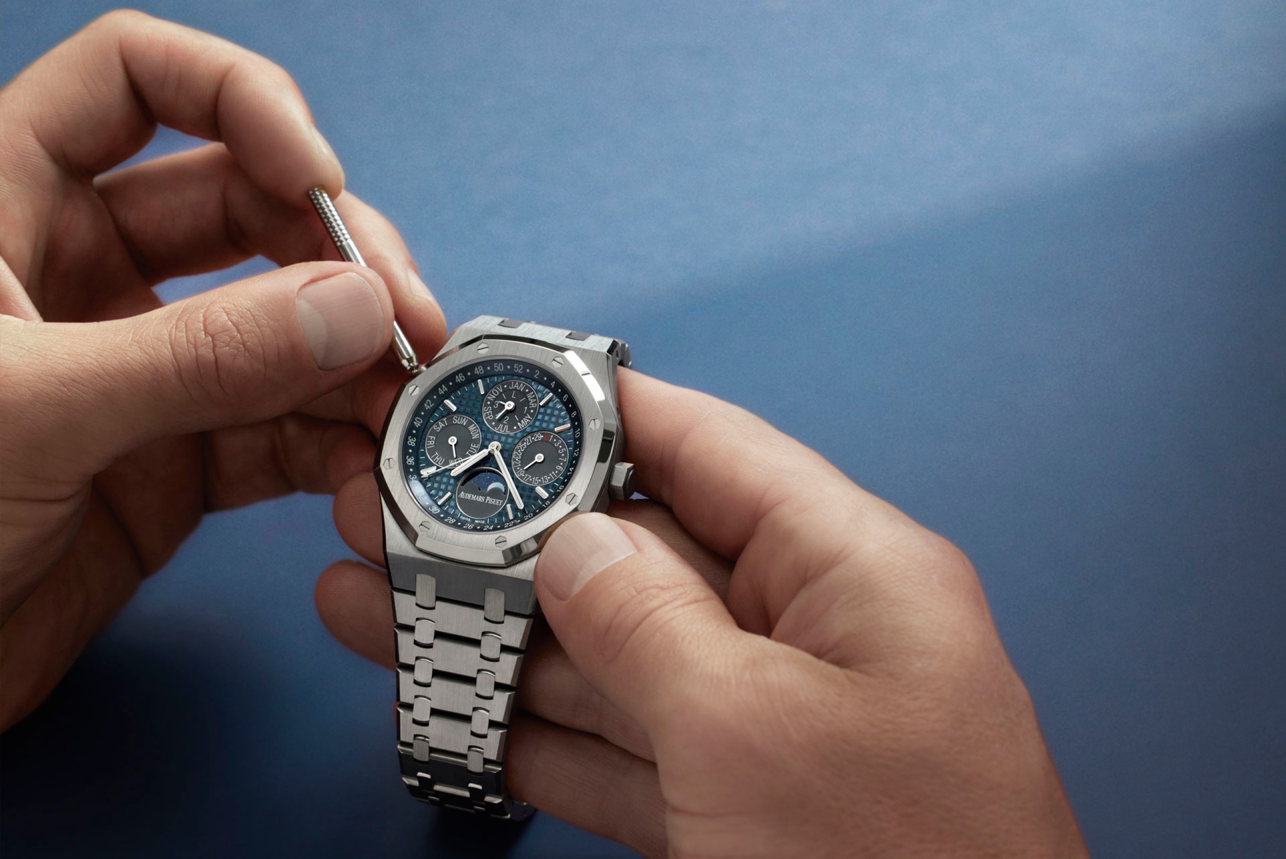 Someone winding a Royal Oak watch.